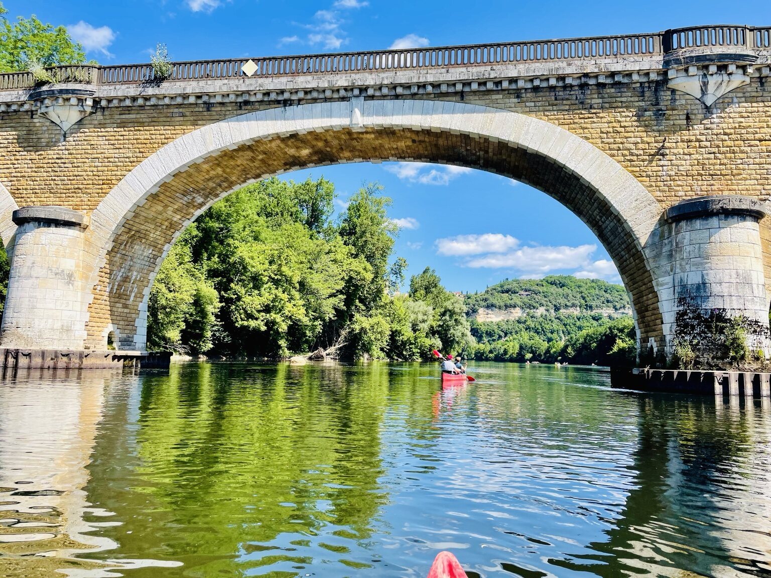 Kayaking on the Dordogne beneath a great stone bridge
